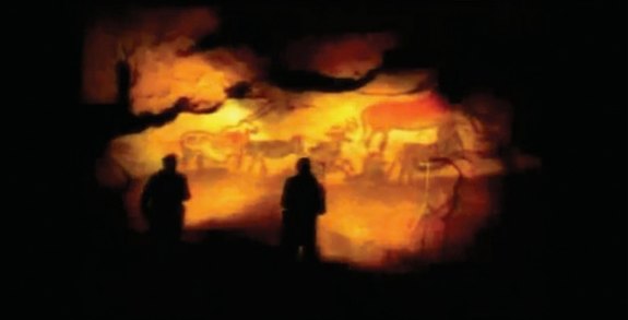 Two silhouettes before the painted wall of Lascaux